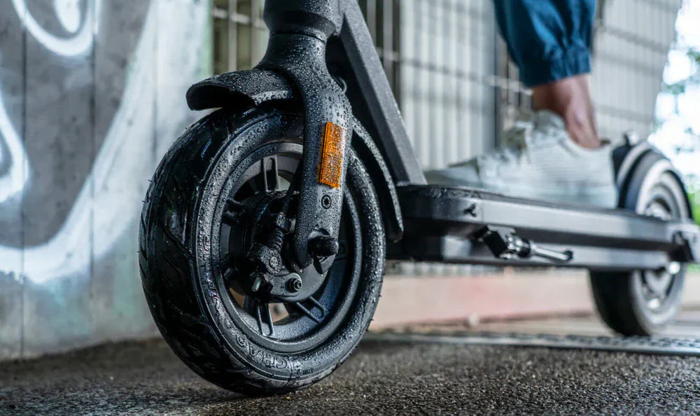 student riding on a scooter